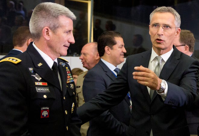NATO Secretary General Jens Stoltenberg, right, speaks with the top commander of U.S. forces in Afghanistan General John Nicholson during a round table meeting of the North Atlantic Council with Resolute Support Operational Partner Nations at NATO headquarters in Brussels, Friday, June 8, 2018. (AP Photo/Virginia Mayo)