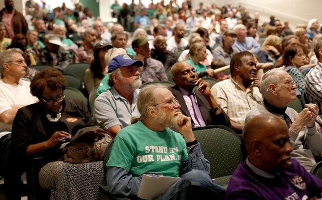 Supporters and opponents of a plan by Plum Creek/Weyerhaeuser for a development east of Gainesville attend a public hearing in 2016. [FILE]