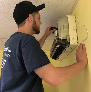 During a recent training seminar, Matt Tuohy, an HVAC technician with R.J. Groner Company, Stroudsburg, sharpens his air-conditioning skills. [AMY LEAP/POCONO RECORD]