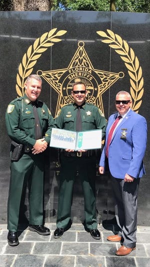 St. Johns County Sheriff's Office Lt. Bobby Dean poses with Cmdr. William Werle (left) and Chief Howard "Skip" Cole (right) upon his 2018 graduation from the Florida Sheriffs Association’s Commanders Academy. [ST. JOHNS COUNTY SHERIFF'S OFFICE]