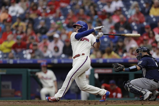 Phillies left fielder Rhys Hoskins hits a sacrifice fly in the fifth inning of Sunday's 4-3 win over the Brewers at Citizens Bank Park. [AP PHOTO / MATT SLOCUM]
