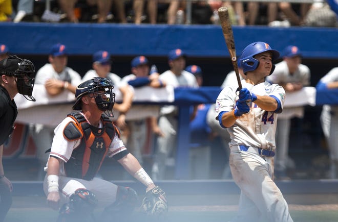 Florida outfielder Austin Langworthy hits a solo home run against Auburn in the top of the ninth inning of the NCAA Super Regional game Sunday at McKethan Stadium. [Cyndi Chambers/Gatehouse Media]