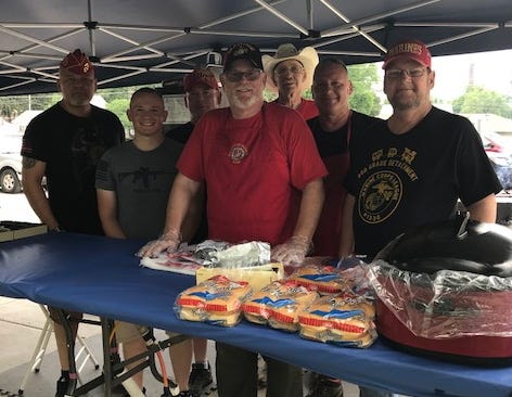 Members of the Marine Corps League donate their time in serving the public pork and ribeye sandwiches during the weekend at the VFW in Lincoln from left are: Raymond Gonzales, Jacob Stauffer, Bill Stauffer, Michael Downem, Gene Hickey, Jim Harnacke and Jack Bishop. [Photo by The Courier}