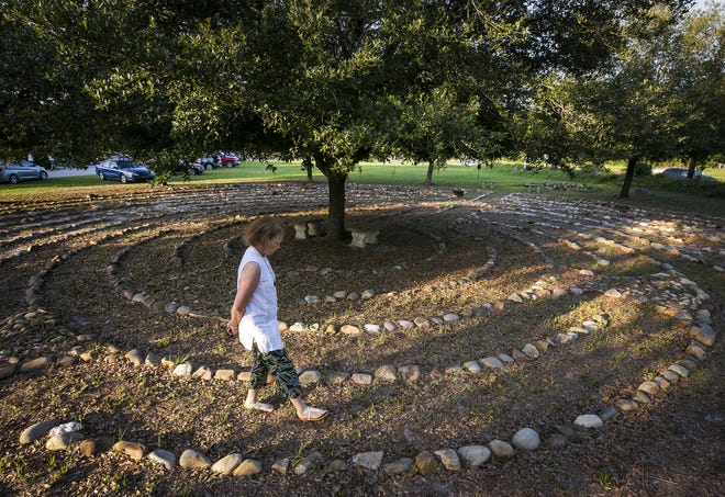 Jessica McCune walks the concentric 11-ring labyrinth at the First Congregation United Church of Christ. "When I enter, I list all the things I'm grateful for and walk to the center. On the way out I do my prayer requests," McCune said. Labyrinths were created for monks who wanted a symbolic religious pilgrimage because they were too old or infirm to make the trek, she said. [Doug Engle/Staff photographer]