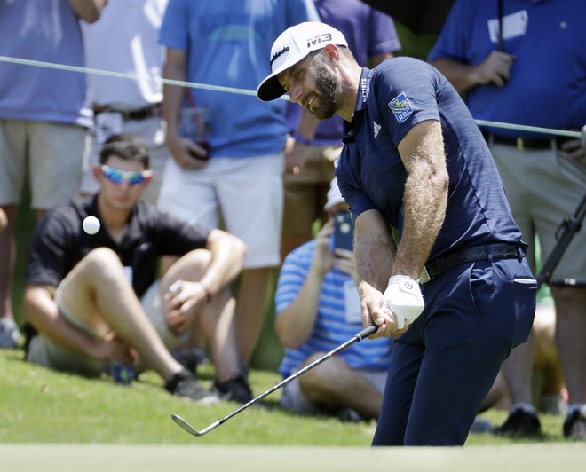 Dustin Johnson chips onto the No. 5 green during the final round of the St. Jude Classic on Sunday in Memphis, Tenn. Johnson took a bogey on the hole. [MARK HUMPHREY/THE ASSOCIATED PRESS]