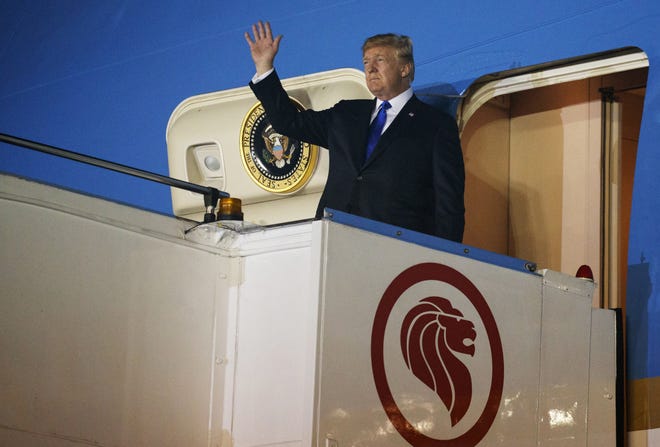 President Donald Trump arrives at Paya Lebar Air Base for a summit with North Korea's leader Kim Jong Un, Sunday in Singapore. [Evan Vucci/Associated Press]