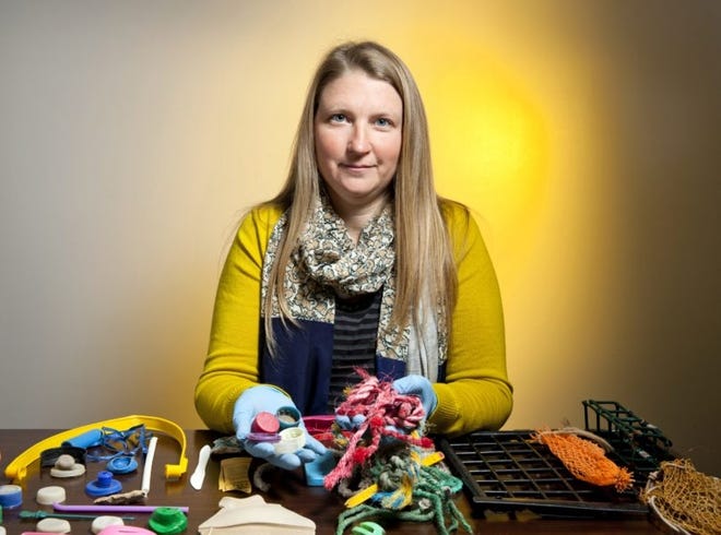UGA associate professor Jenna Jambeck holds up plastic and other trash gathered from the ocean. [Contributed]