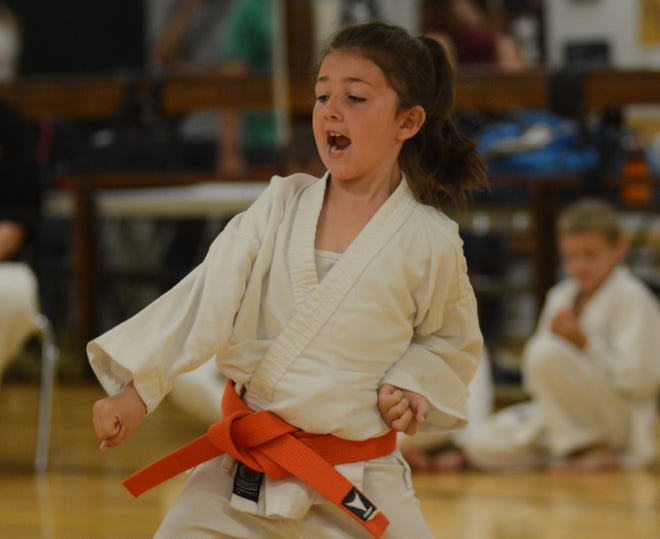 Rochester's Adriana Johnson, 7, competes in championship kata during the recent Rochester Youth Karate League's finals at the Rochester Community Center. [Mike Whaley/Fosters.com]