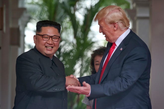U. S. President Donald Trump shakes hands with North Korea leader Kim Jong Un at the Capella resort on Sentosa Island Tuesday, June 12, 2018 in Singapore. (Kevin Lim/The Straits Times via AP)