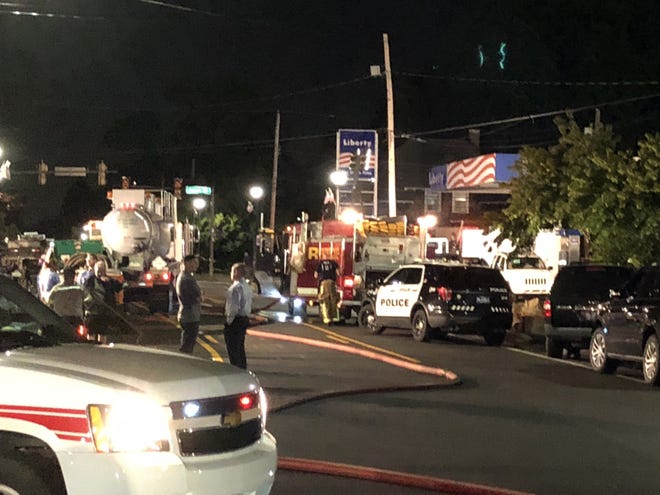Rescue crews work into the night Tuesday to try to save the gas station worker trapped under piles of concrete. [Joan Hellyer / Staff Photojournalist]