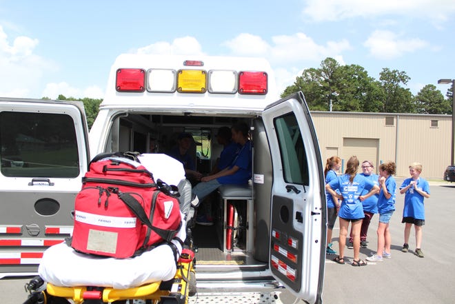Youth in the Van Buren Police Department's Summer Youth Academy line up to see the inside of a Southwest EMS vehicle on Monday, June 11, 2018. [MAX BRYAN/TIMES RECORD]
