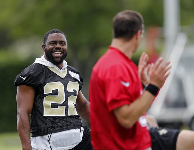 New Orleans Saints running back Mark Ingram (22) talks with quarterback Drew Brees during practice in Metairie, La., Tuesday. [The Associated Press]