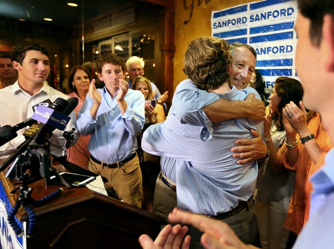 U.S. Rep. Mark Sanford hugged his sons after addressing his supporters at Liberty Tap Room in Mount Pleasant, S.C., Tuesday. Sanford lost his first election ever Tuesday, beaten for the Republican nomination for another term in the coastal 1st District around Charleston by state Rep. Katie Arrington. [Wade Spees/The Post And Courier via AP]