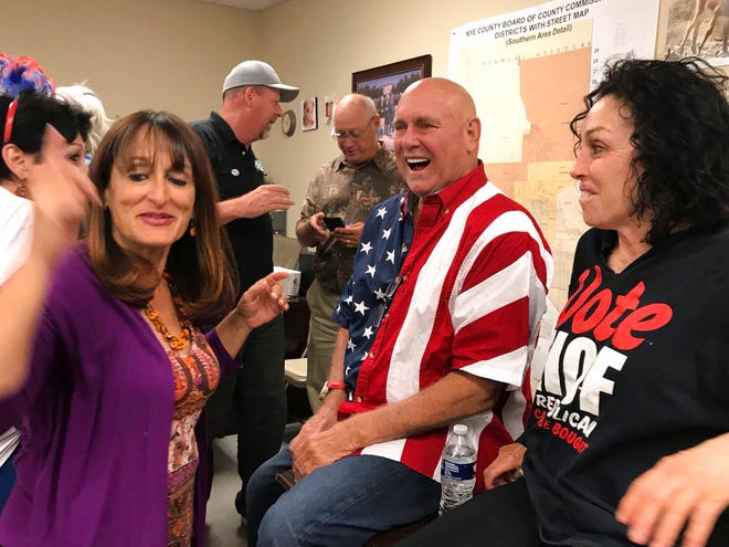 In this Tuesday photo, Nevada brothel owner Dennis Hof, second from right celebrates after winning the primary election in Pahrump, Nev. Hof, the owner of half a dozen legal brothels in Nevada and star of the HBO adult reality series "Cathouse," won a Republican primary for the state Legislature on Tuesday, ousting a three-term lawmaker. At right is former madam and reality TV personality Heidi Fleiss. (David Montero /Los Angeles Times via AP)