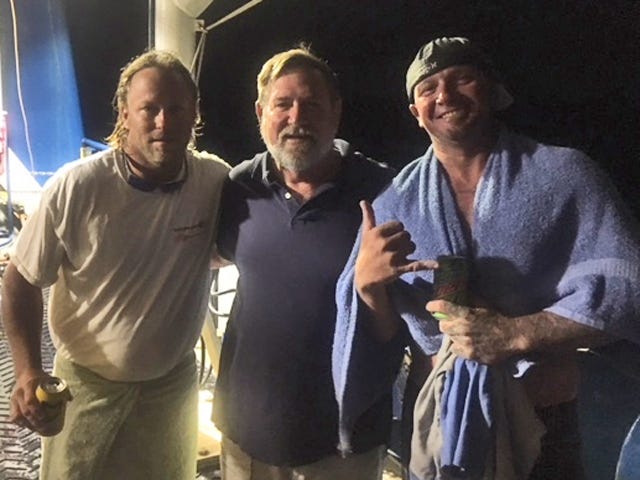 Skidaway Institute of Oceanography's research vessel, The Savannah, rescued two capsized fisherman off the coast of Florida on June 8. Here, Savannah Capt. Raymond Sweatte is flanked by rescued boaters Justin DeSoto (right) and Andy Odom. [Courtesy Skidaway Institute]