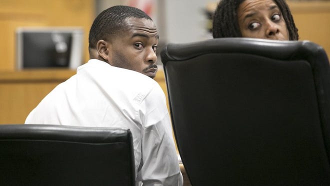 Jabari Mitchell, at left with attorney Leslie Booker, is accused of shooting his ex-girlfriend’s brother, Trelin Reed, at a North Austin convenience store. The jury will continue deliberating in Mitchell’s murder trial on Wednesday. RALPH BARRERA / AMERICAN-STATESMAN