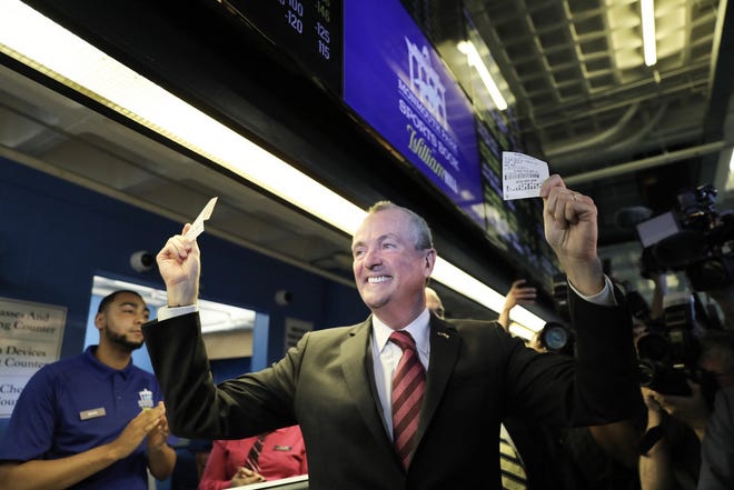 Gov. Phil Murphy casts the first sports bets at a ceremony at Monmouth Park racetrack in Oceanport. [COURTESY OF NJ GOVERNOR'S OFFICE]