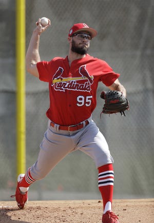 St. Louis Cardinals pitcher Daniel Poncedeleon throws during a spring training baseball workout on Feb. 14 in Jupiter, Fla. A little more than a year after a life-threatening brain injury, Daniel Poncedeleon is ready to make his major league debut. The St. Louis Cardinals bought the 26-year-old right-hander's contract from Triple-A Memphis on Monday before they opened a three-game series against the San Diego Padres. [David J. Phillip/Associated Press)