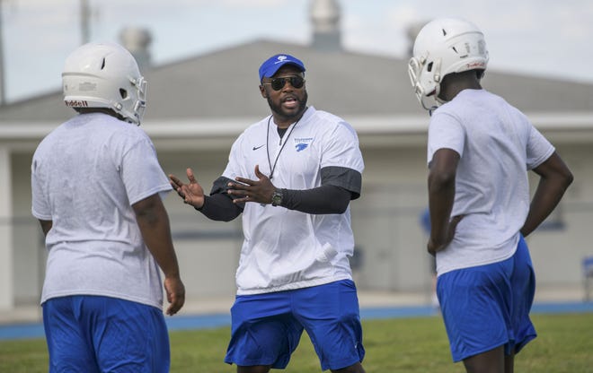 Wildwood football coach McKinley Rolle talks with his defense during practice at the school on April 23. Rolle announced Thursday he was stepping down at Wildwood to take a job as an assistant coach at Garden City Community College in Kansas. [PAUL RYAN / CORRESPONDENT]