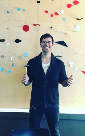 Artist Aaron Stanley stands with some of his kinetic artwork at The Art Center in Dover. There will be a reception at the exhibit on Friday, June 15 from 6 to 9 p.m. [Courtesy photo]