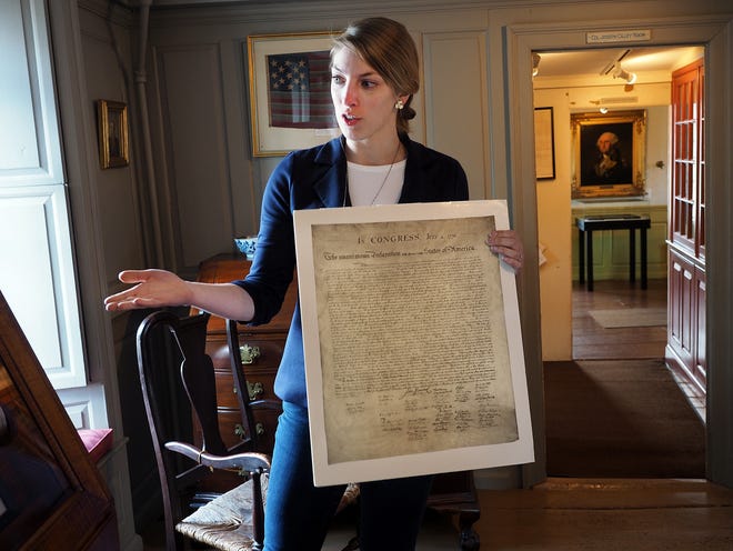 Emma Bray, executive director of the American Independence Museum, holds a copy of the Declaration of Independence, while talking about The Dunlap Broadside, one of the collection highlights of the museum, which opened for the season on May 1. [Rich Beauchesne/Seacoastonline]