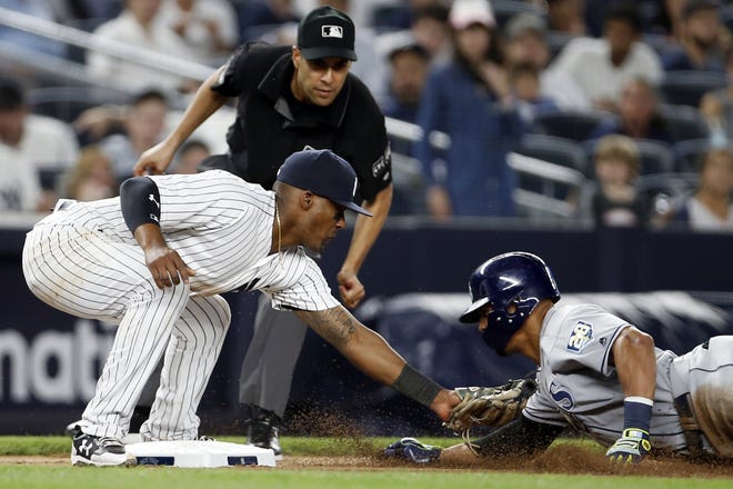 New York Yankees third baseman Miguel Andujar tags out Tampa Bay's Carlos Gomez on an attempted steal during the seventh inning of their game Thursday night. [ADAM HUNGER/THE ASSOCIATED PRESS]