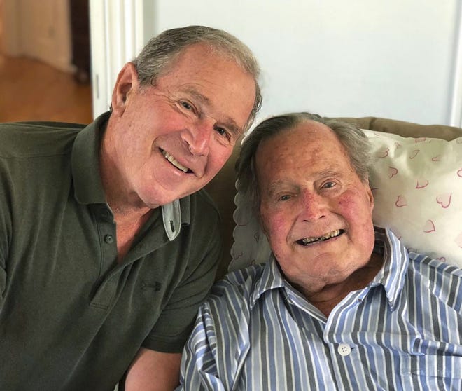 In this photo provided by the Office of George W. Bush, former U.S. presidents George H.W. Bush and his son pose for a photo in Kennebunkport Tuesday, June 12. Bush enjoyed a relaxing birthday on Tuesday as he became the first former U.S. president to turn 94. [Office of George W. Bush via AP]