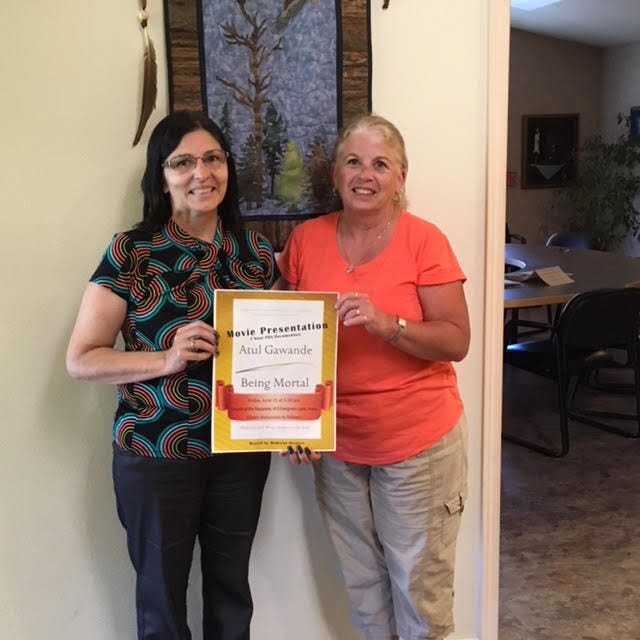 Pictured here are Madrone Hospice Executive Director Terrie Berentsen, left, and LVN Susan Sorenson with a poster of Madrone’s presentation of “Being Mortal.”