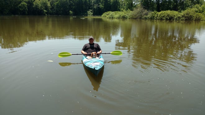 SUBMITTED PHOTO 

Rev. Tom Dunkle and his dog Bella are shown in a kayak. The senior minister of Dover St. John's United Church of Christ is offering to lead small groups of kayakers on devotional adventures in July.