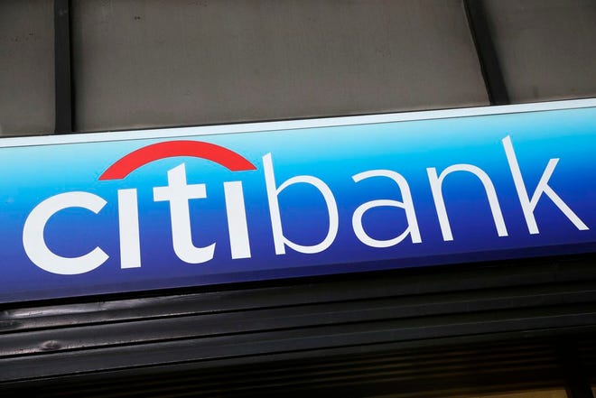 FILE - In this Jan. 15, 2015, file photo, a Citibank sign hangs above a branch office in New York. Citigroup is agreeing to pay $100 million to settle charges that its bankers manipulated an important interest rate used to price everything from credit cards to mortgages. (AP Photo/Mark Lennihan, File)