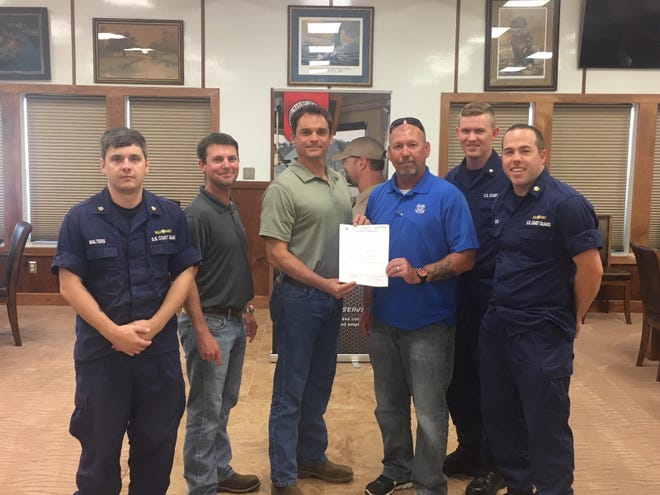 Petty Officer Andrew Walters (from left), Cenac Compliance Manager Dustin Walker, Cenac Safety Manager Tim Moore, Jeff Scott, Petty Officer Joshua Mull and Petty Officer Cory Basso are shown with the certificate of inspection. [Submitted]
