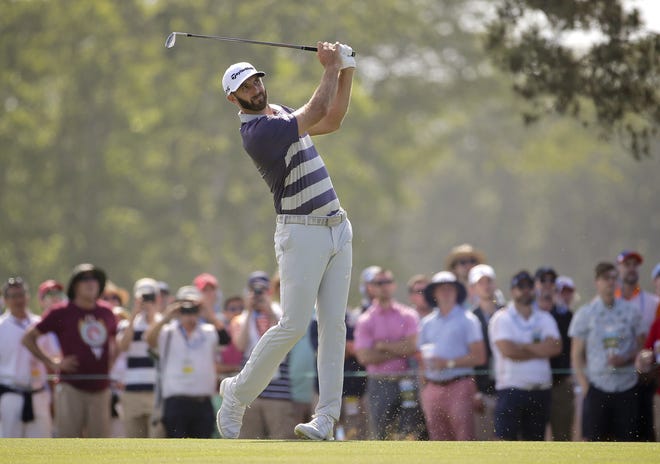 Dustin Johnson hits on the fifth hole during the third round of the U.S. Open Golf Championship on Saturday in Southampton, N.Y. [AP Photo / Seth Wenig]