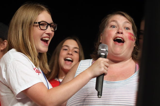 Burlington Steamboat Days Sweetheart Kaylin Moeller holds the microphone for Sandi Dean while singing karaoke Friday during Special Guest Day at Memorial Auditorium. Besides karaoke the event also featured face painting, lunch and dancing. [John Lovretta/thehawkeye.com]