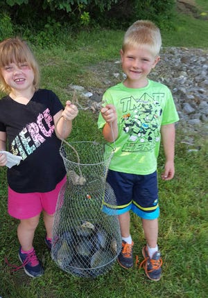 Aubry and Hayden Galbreath with a fish basket full of bluegills Friday morning. They're the grandchildren of Al Hayden. [SUBMITTED PHOTO]