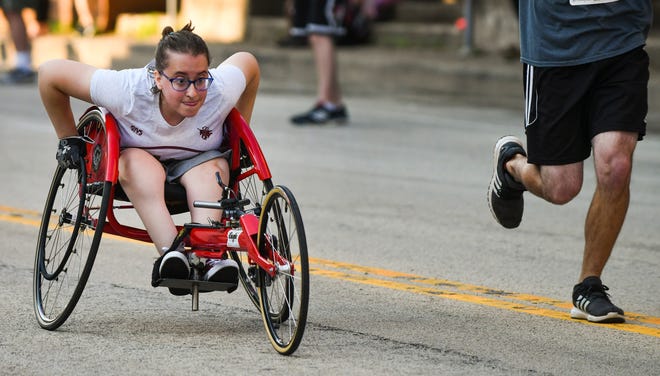 RON JOHNSON/JOURNAL STAR Savanna Klobnak takes off from the start of the 4-mile wheelchair race, winning the event during the 45th annual Steamboat Classic.