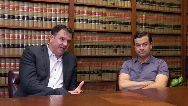 Javier Gonzalez, right, and his lawyer Richard Hujber meet to discuss their strategy after Javier had an ankle monitor put on him during his immigration meeting today, June 12, 2018. Gonzalez crossed the border into the United States illegally 17 years ago, and that illegal crossing has been an obstacle in his efforts to obtain a green card. When asked how his wife reacted after learning the outcome of his immigration meeting today Javier said it destroyed her. (Damon Higgins / The Palm Beach Post)