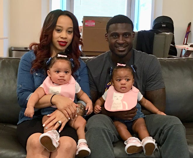 Jennifer Claiborne, left, holds daughter Ma'Liah, while husband and New York Jets cornerback Morris Claiborne holds daughter Ma'Kaila Thursday at their home in Whippany, N.J. Last summer, Claiborne was trying to settle in with his new team, but his mind was on his newborn twins, one of whom was born underweight. [AP Photo/Dennis Waszak Jr.]