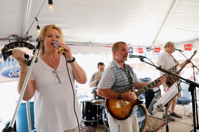 Jeanne Bell sings along with fellow members of the Parkside Praise Team, during the first Burlington Steamboat Days Praise Fest, Sunday at the Missi Sippin' Landing. The event featured five local Christian bands as well as seven community speakers, kid's activities and a free lunch. [John Lovretta/thehawkeye.com]