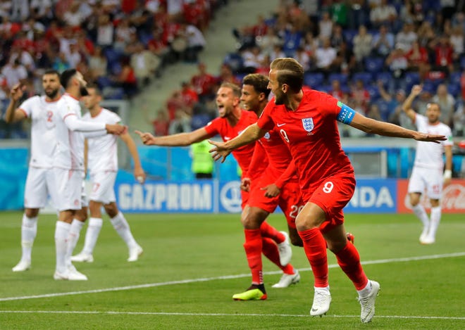 England's Harry Kane, foreground right, celebrates after scoring his side's opening goal against Tunisia during the group G match between Tunisia and England at the 2018 soccer World Cup in the Volgograd Arena in Volgograd, Russia, Monday, June 18, 2018. (AP Photo/Sergei Grits)