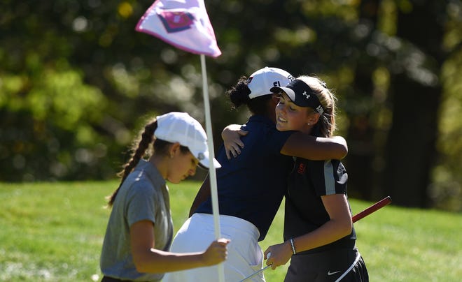 Sewickley Academy's Tatum McKelvey, right, hugs Central Valley's Kiara Porter as they finish on the 18th hole with Greensburg Central Catholic's Abby Zambruno, far left, during the WPIAL 2A girls individual golf championship at Diamond Run Golf Club last fall. Porter and McKelvey will both play in the PGA Junior Championship this week. [Kevin Lorenzi/ECL Staff File]