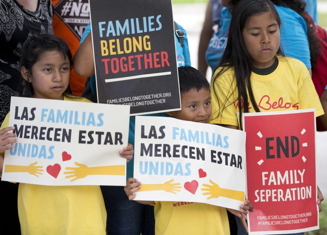 Children hold signs during a demonstration in front of the Immigration and Customs Enforcement offices in Miramar, Fla on June 1. The Trump administration's move to separate immigrant parents from their children on the U.S.-Mexico border has turned into a full-blown crisis in recent weeks, drawing denunciation from the United Nations, Roman Catholic bishops and countless humanitarian groups. [WILFREDO LEE/THE ASSOCIATED PRESS]