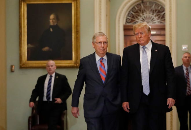 President Donald Trump (right) walks with Senate Majority Leader Mitch McConnell, R-Ky., before attending the weekly Senate luncheons on Capitol Hill in Washington on May 15, 2018. MUST CREDIT: Bloomberg photo by Aaron P. Bernstein.