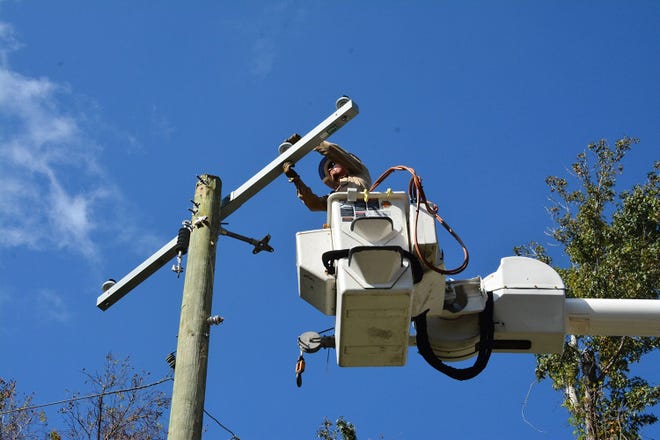 A Gulf Power worker helps restore power after Hurricane Irma. [CONTRIBUTED PHOTO]