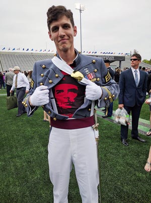 In this May 2016 photo provided by Spenser Rapone, Rapone displays a shirt bearing the image of socialist icon Che Guevara under his uniform, after graduating from the United States Military Academy at West Point. After Rapone, who was already a combat veteran after serving with the First Ranger Battalion in Afghanistan, posted the photo on Facebook, the Army dismissed him with an "other than honorable" discharge. [COURTESY SPENSER RAPONE/ASSOCIATED PRESS]