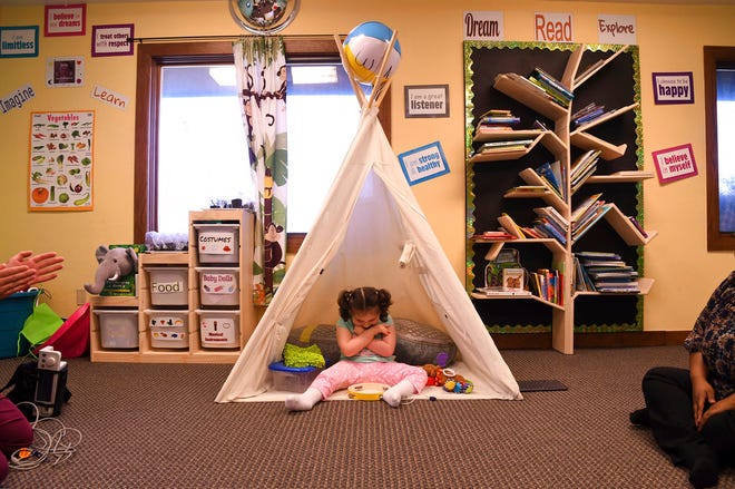 In this April 23, 2018, photo, Addelyn Patrick, 5, sits inside a teepee in the playroom at Realm of Caring in Colorado Springs, Colo. Addelyn was born with a brain malformation and suffers from multiple forms of seizures. The U.S. Food and Drug Administration is expected to decide soon whether to give its first approval to a prescription drug made from the marijuana plant. But parents, including Addelyn's mother Meagan Patrick, who have used other products containing chemicals from the plant to treat their childrenâ€™s severe forms of epilepsy are feeling more cautious than celebratory. (AP Photo/Thomas Peipert)
