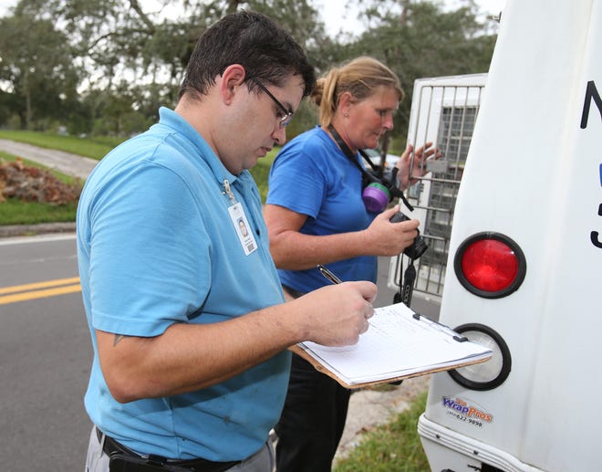The proposed Marion County government budget calls for an increase in the countywide base millage rate. Here, workers with Marion County Animal Services handle a call in Northeast Ocala on Oct. 5. [Bruce Ackerman/Staff photographer]