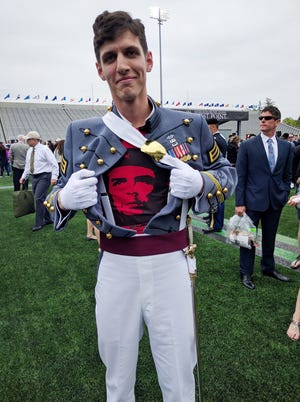 In this May 2016 photo provided by Spenser Rapone, Rapone displays a shirt bearing the image of socialist icon Che Guevara under his uniform, after graduating from the United States Military Academy at West Point, N.Y. After Rapone, who was already a combat veteran after serving with the First Ranger Battalion in Afghanistan, posted the photo on Facebook, the Army dismissed him with an "other than honorable" discharge. (Courtesy of Spenser Rapone via AP)