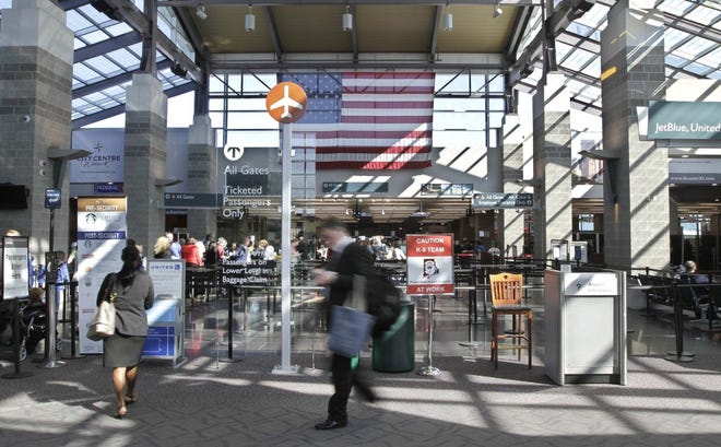 Passengers come and go at the T.F.Green Airport terminal. The House Corporations Committee on Tuesday voted in favor of a bill that would change the name to Rhode Island International Airport. [The Providence Journal, file / Kris Craig]