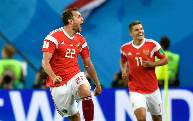 Russia's Artyom Dzyuba, left, celebrates after scoring his side's third goal against Egypt.
