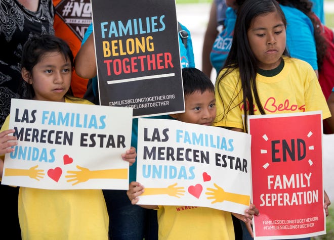 FILE - In this June 1, 2018, file photo, children hold signs during a demonstration in front of the Immigration and Customs Enforcement offices in Miramar, Fla. The Trump administration's move to separate immigrant parents from their children on the U.S.-Mexico border has turned into a full-blown crisis in recent weeks, drawing denunciation from the United Nations, Roman Catholic bishops and countless humanitarian groups. (AP Photo/Wilfredo Lee, File)